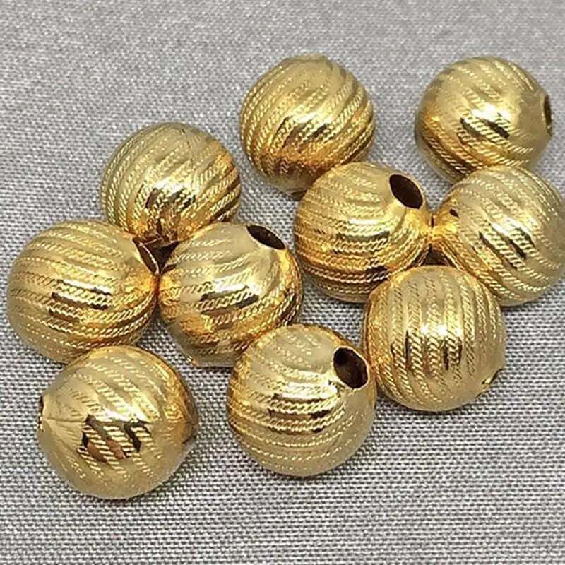 10 vintage etched brass metal beads, 8mm, with gold color and decorative texture.